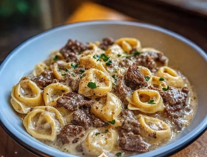 Cheesesteak tortellini in rich provolone sauce with peppers and onions.