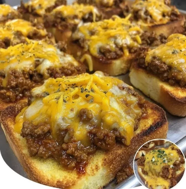 Cheesy Sloppy Joe Garlic Toast topped with melted cheese and garlic