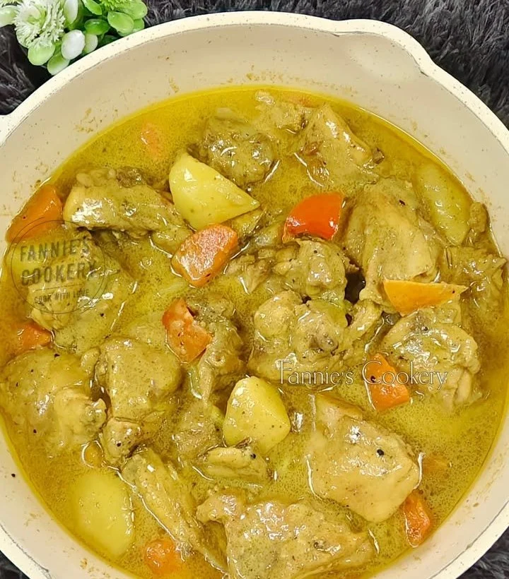 Delicious chicken curry Filipino style served in a bowl with rice and herbs