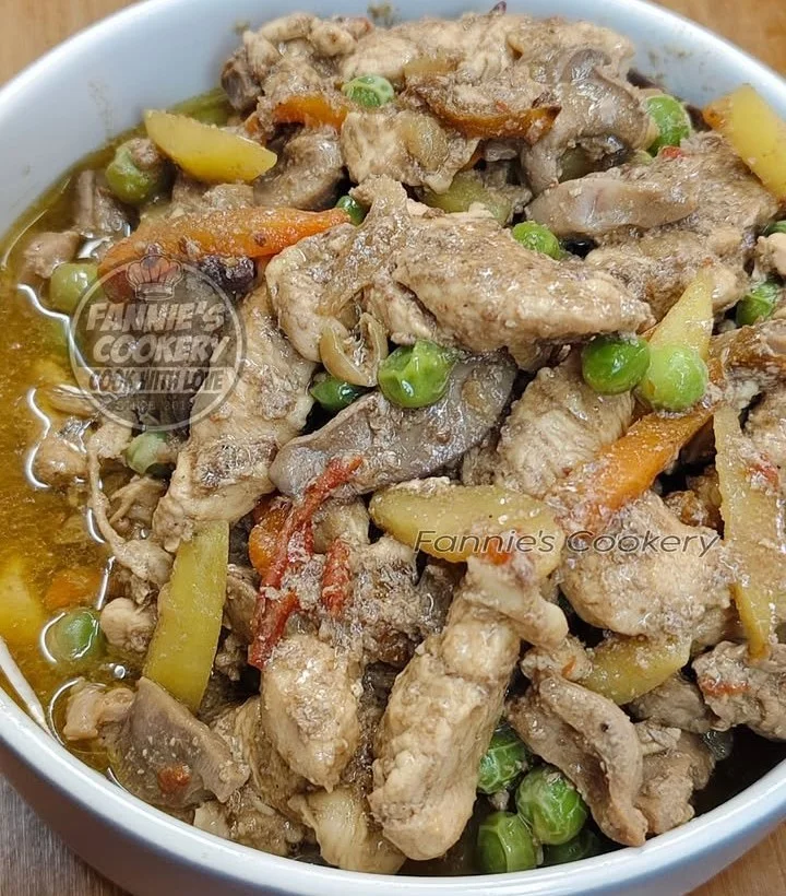 Plate of Chicken IGADO served with rice, showcasing its rich soy sauce flavor.