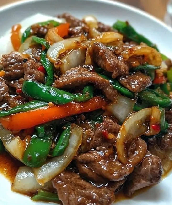 Chinese Beef and Onion Stir-Fry with colorful vegetables in a bowl