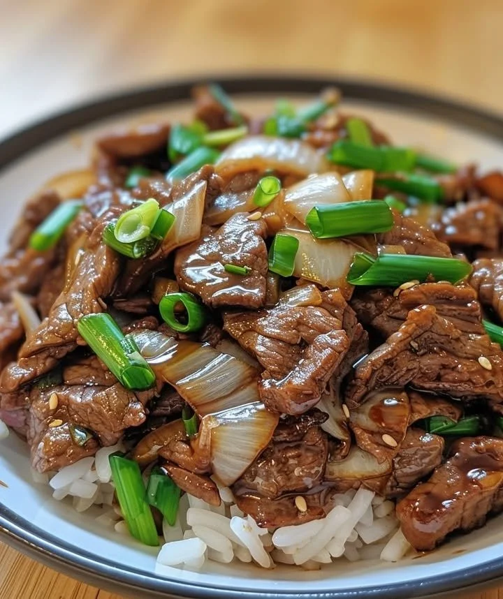 Chinese Beef & Onion Stir-Fry with colorful vegetables in a skillet