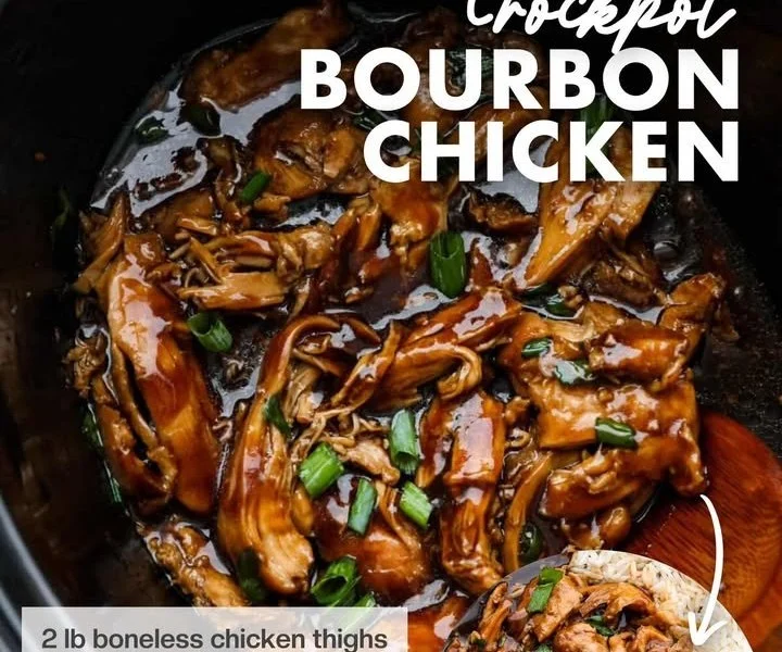 Delicious Crockpot Bourbon Chicken served on a plate with rice and vegetables.