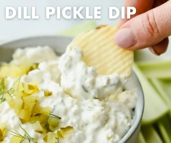 A bowl of colorful and flavorful dip served with fresh vegetables and crackers.