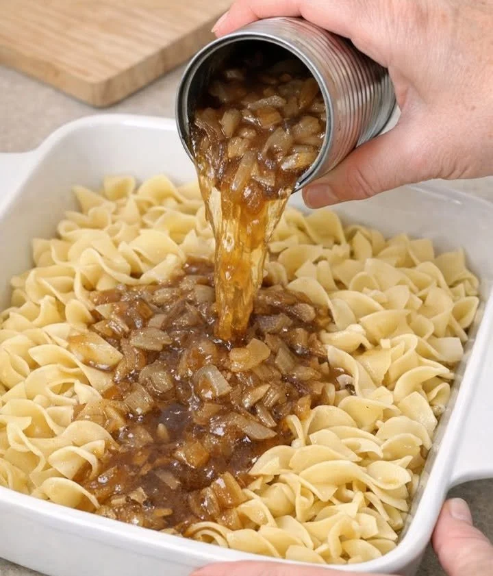 French onion noodle casserole topped with melted cheese and crispy onions