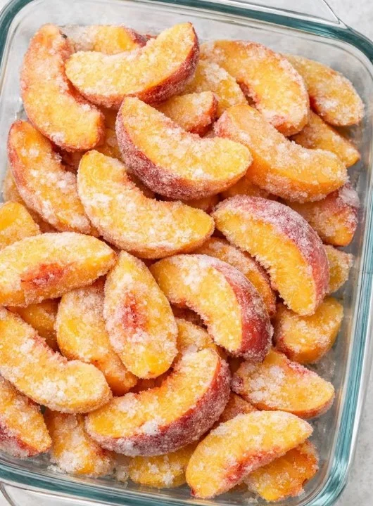 Delicious frozen peach crisp dessert topped with oats and cinnamon