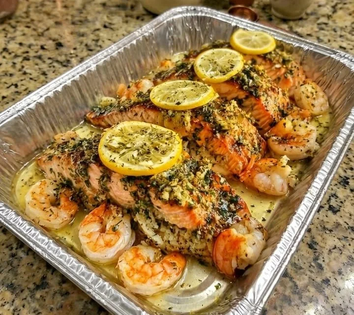 Herb butter lemon salmon and shrimp bake dish ready to serve