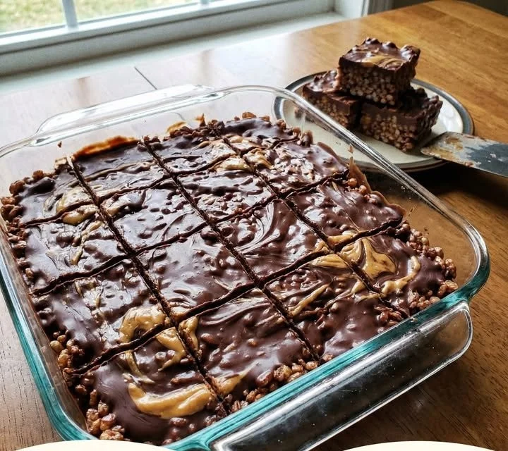 No-bake chocolate peanut butter rice krispie treats on a plate.