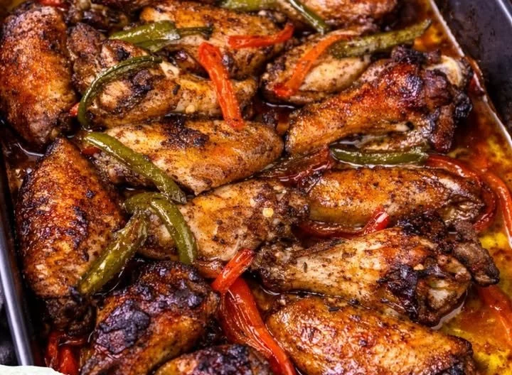 Oven baked honey jerk chicken garnished with herbs and spices