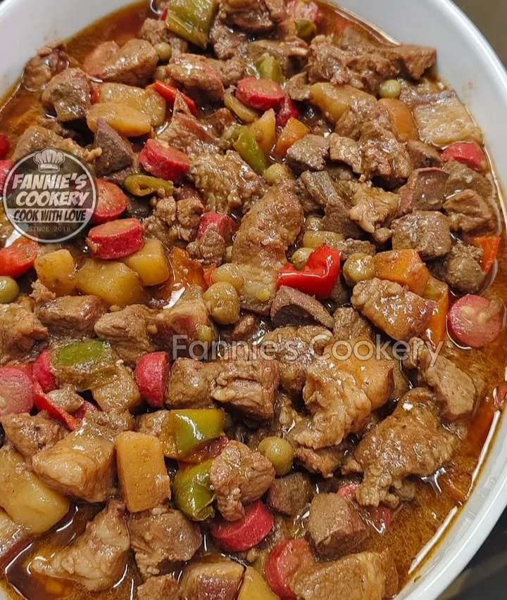 Delicious bowl of Pork Menudo served with vegetables and rice