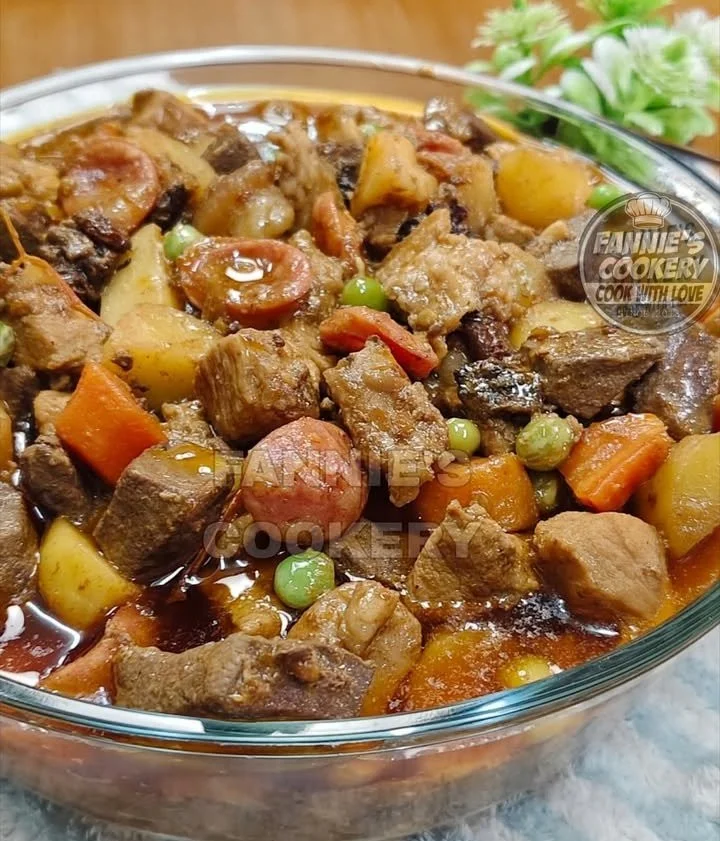 Delicious Pork Menudo served in a bowl with vegetables and spices