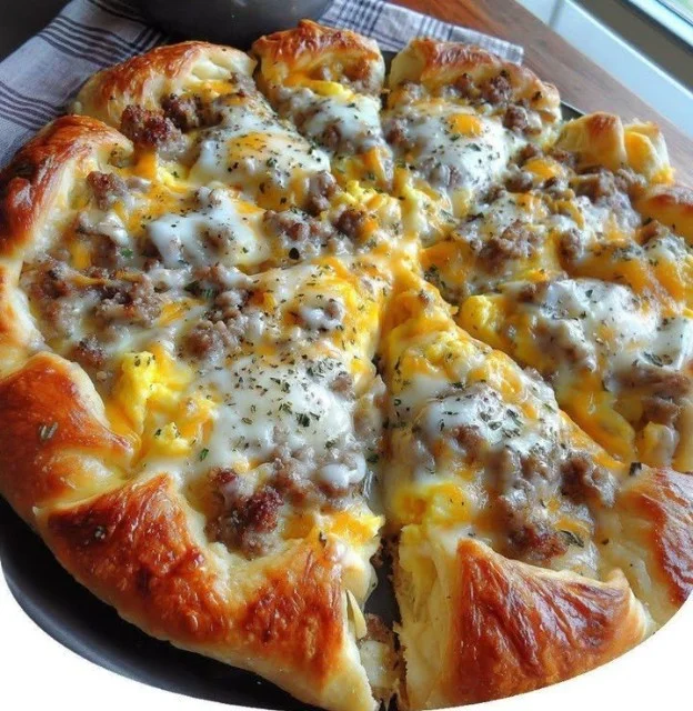 Sausage Gravy Breakfast Pizza with toppings on a crust, perfect for breakfast.