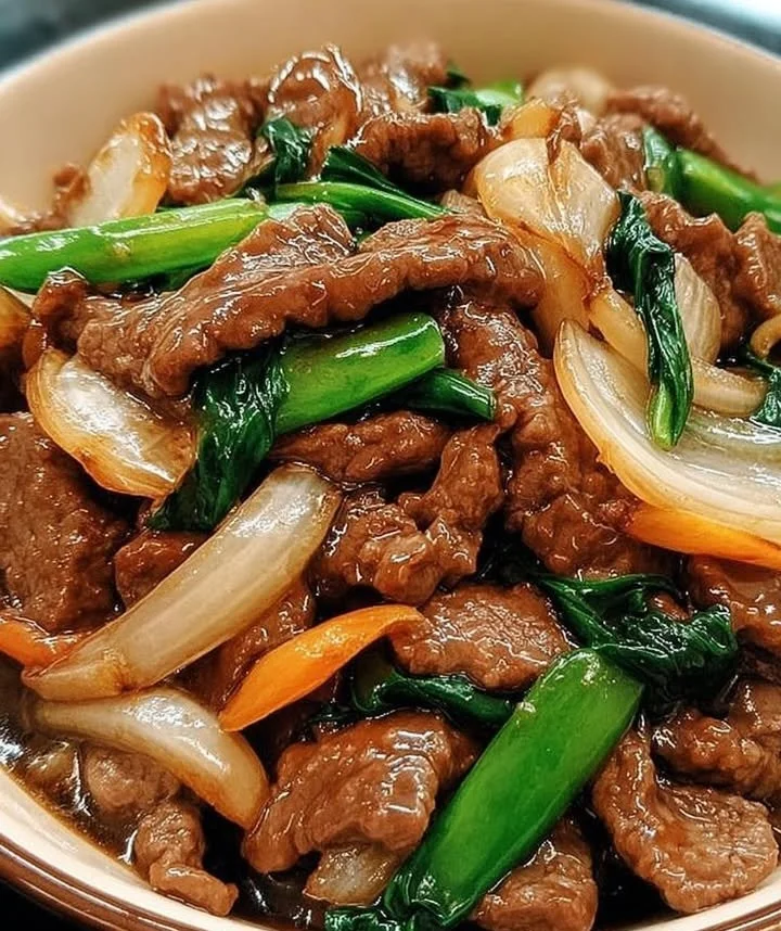 Sizzling Cantonese-style beef and sweet onions in a skillet