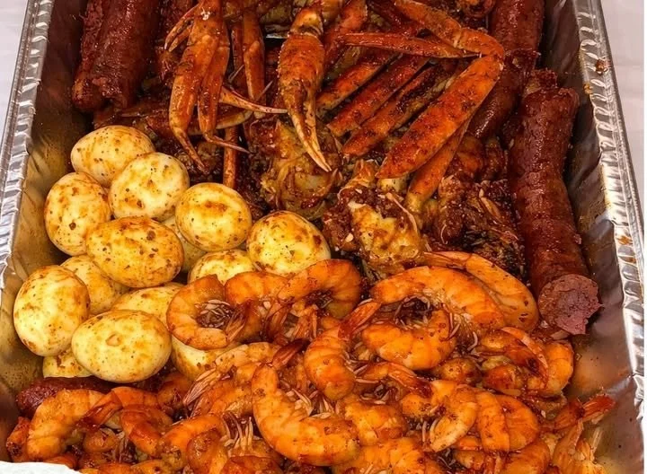 Delicious spicy Cajun seafood boil with shrimp, crab, and corn.