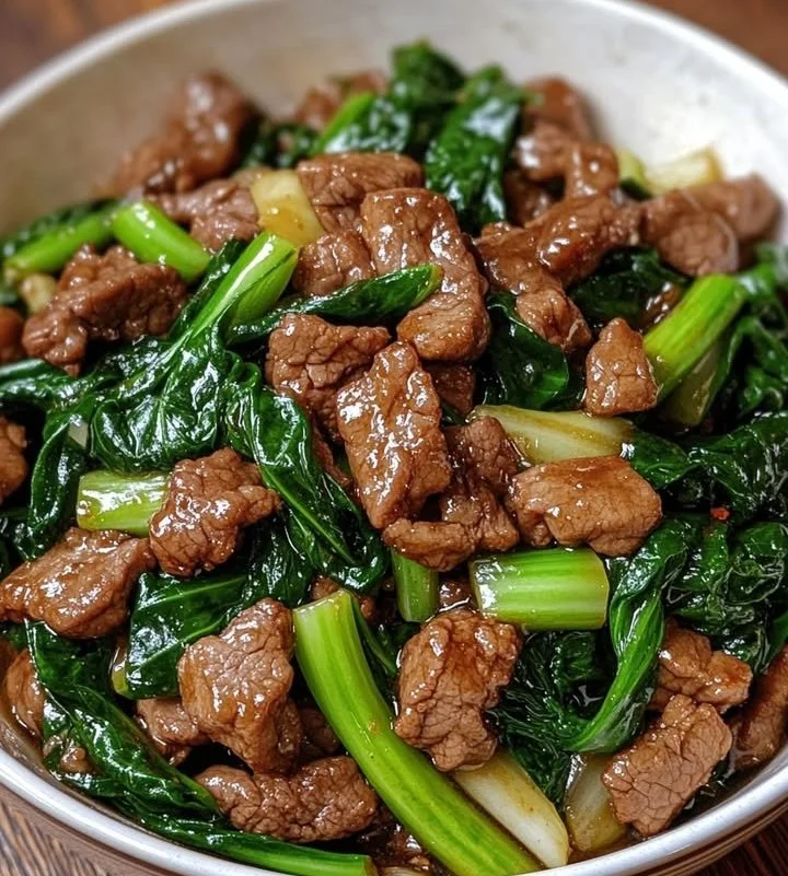 Stir-fried beef and bok choy in a savory wok sauce served in a bowl.