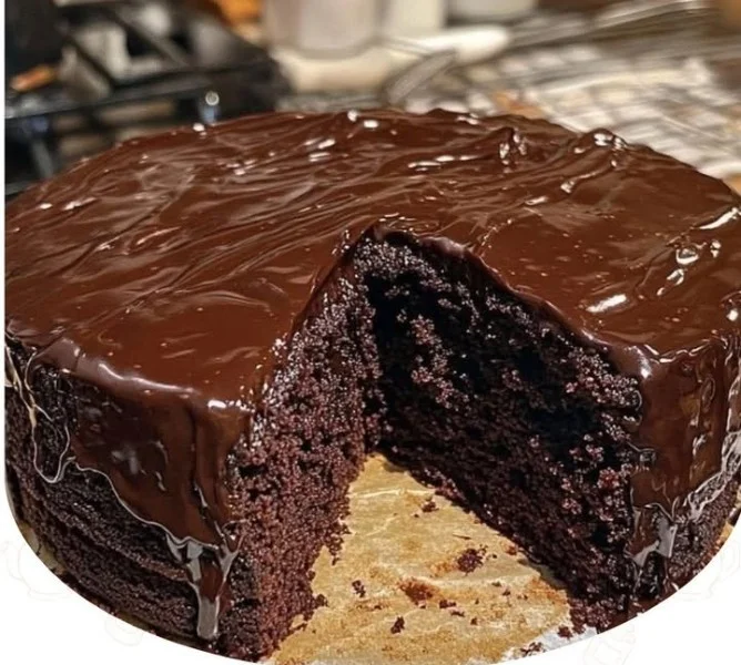 Ultimate moist chocolate fudge cake topped with chocolate icing and sprinkles