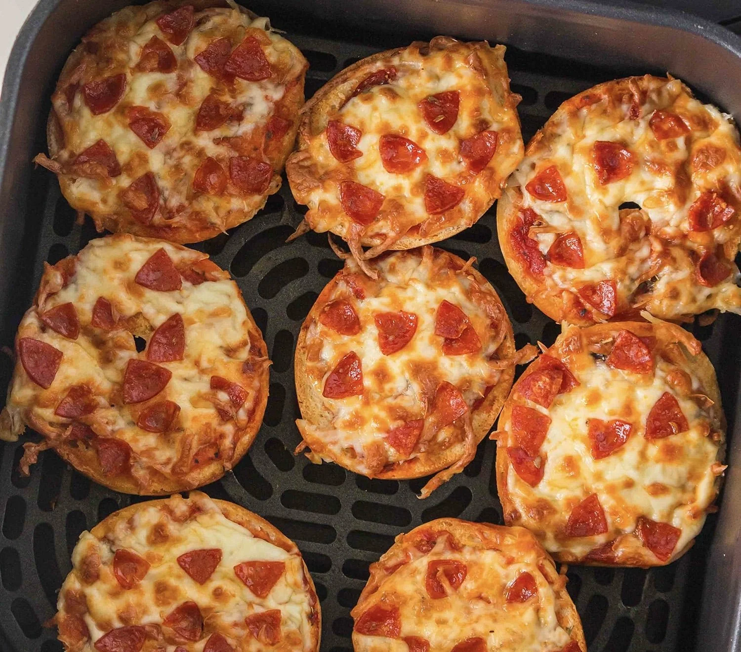 Homemade Air Fryer Bagel Pizza topped with cheese and pepperoni