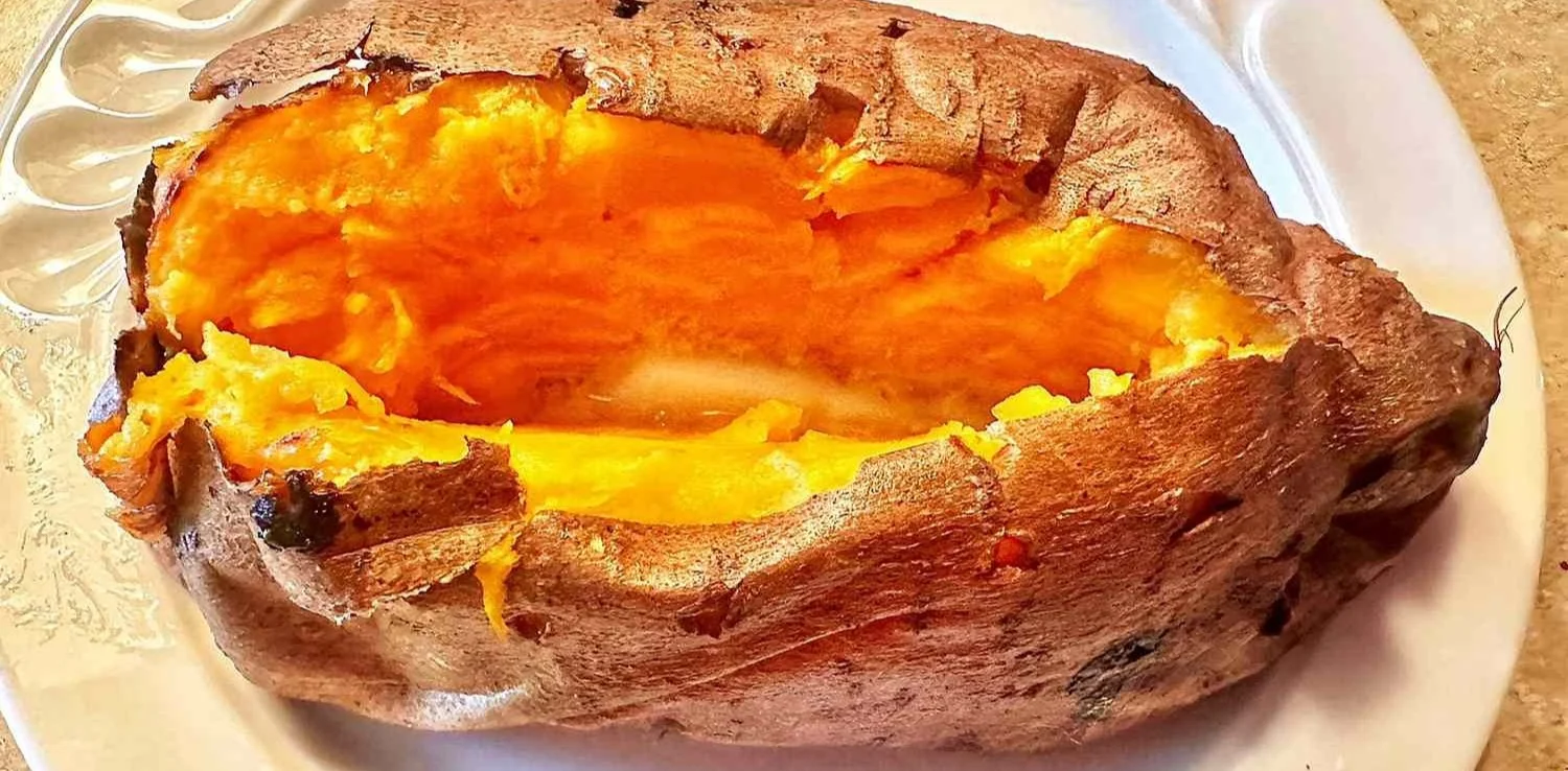 Delicious air fryer baked yams served on a plate with garnishes
