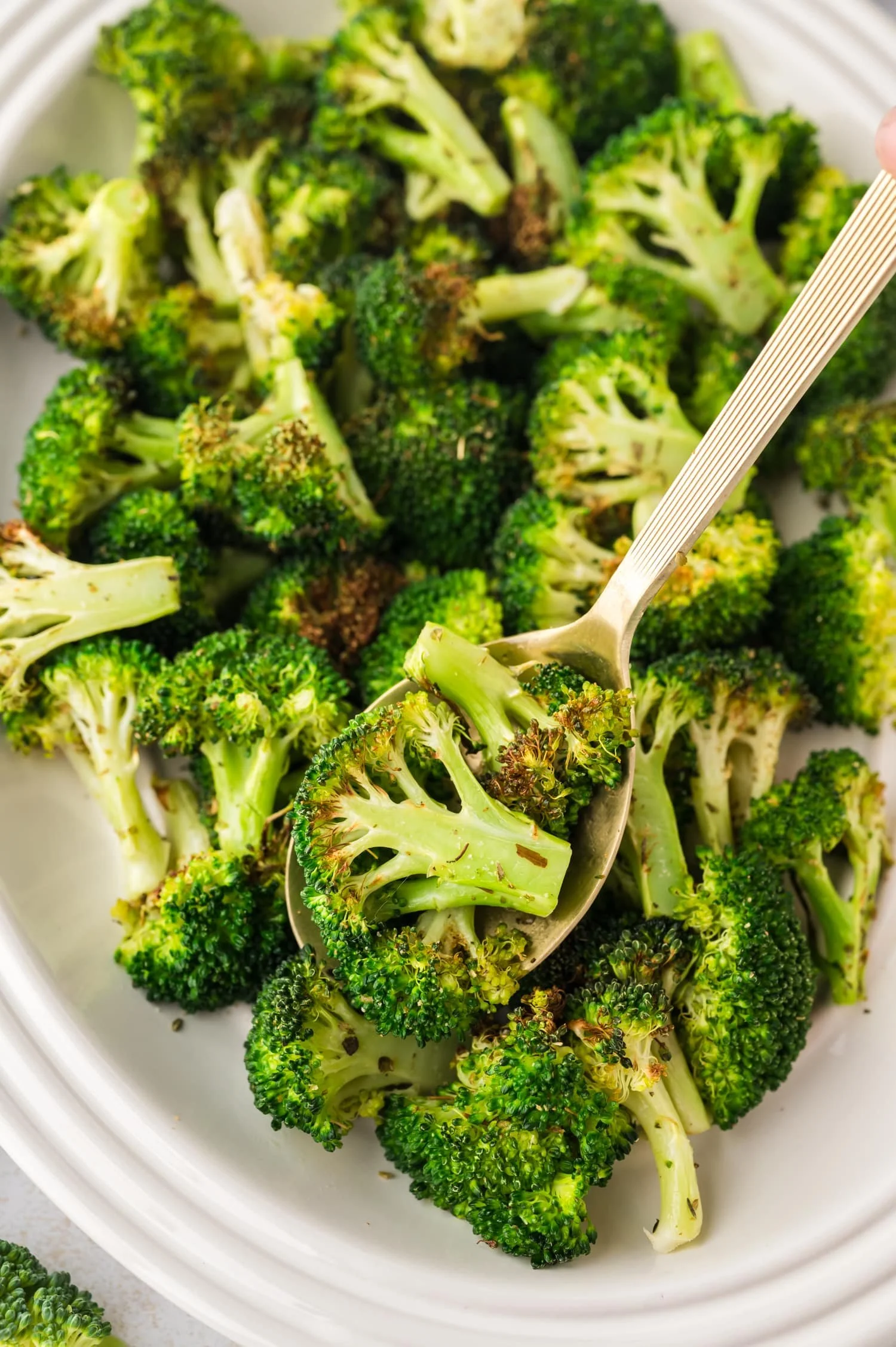 Crispy air fryer broccoli served in a bowl with seasonings