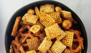 Delicious Air Fryer Chex Mix in a bowl, perfect for snacks and gatherings.