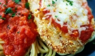 Crispy Air Fryer Chicken Parmesan served with marinara sauce and cheese