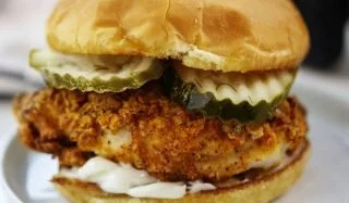 Delicious air fryer chicken sandwich topped with lettuce and tomato