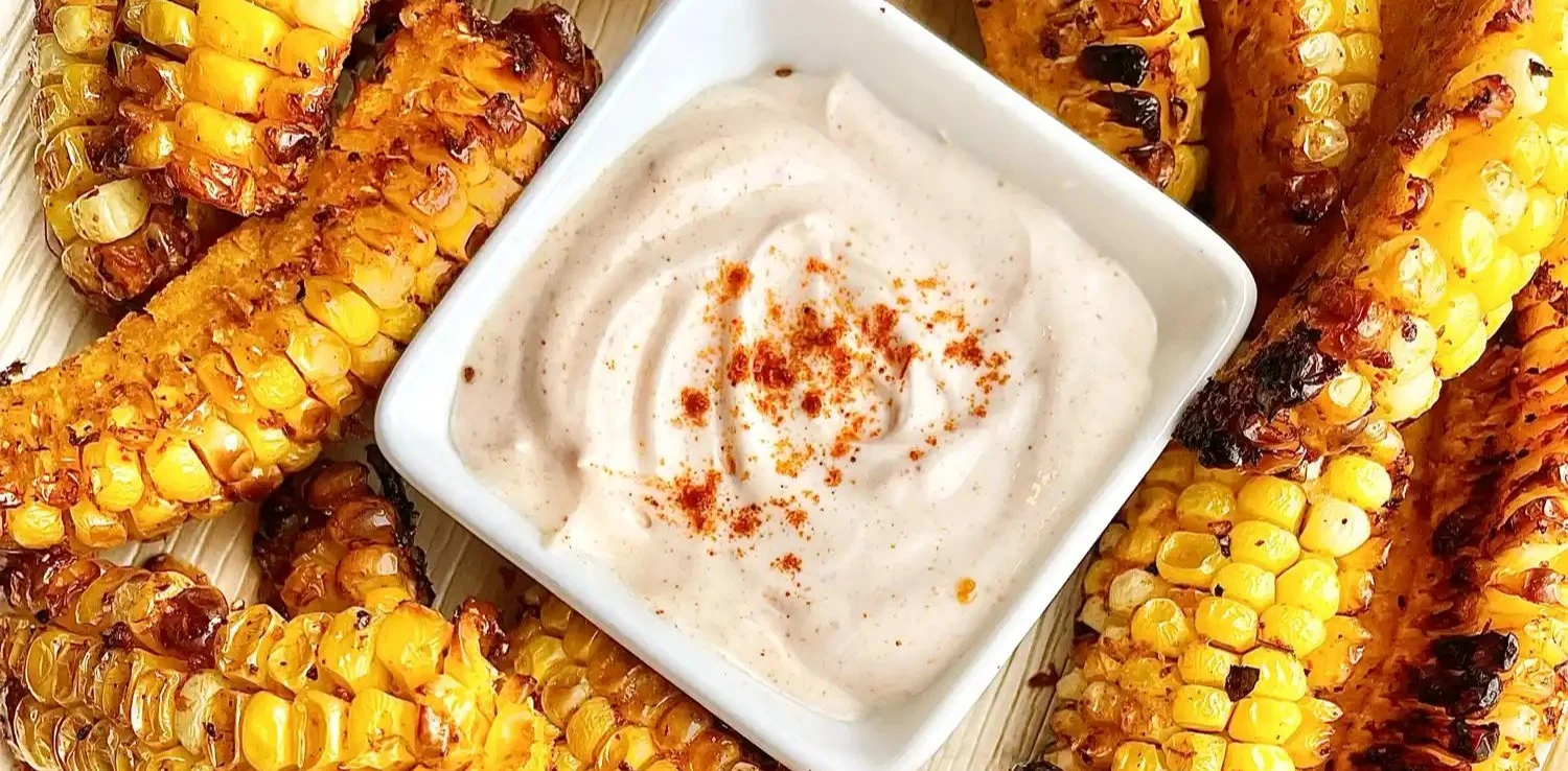 Delicious air fryer corn ribs served with zesty sour cream for a tasty dish
