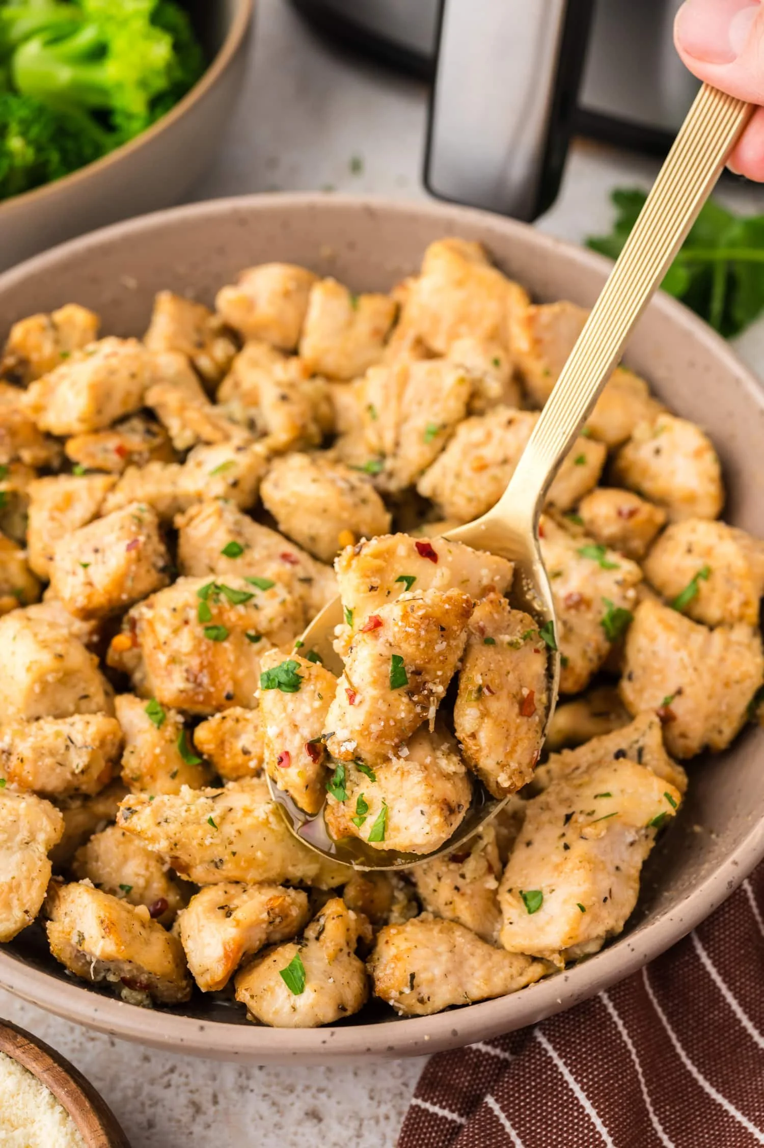Air Fryer Garlic Parmesan Chicken garnished with herbs and spices