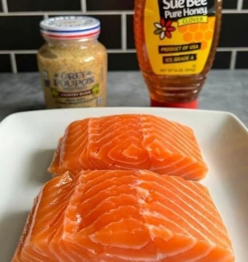 Air Fryer Honey Mustard Salmon dish on a plate garnished with herbs
