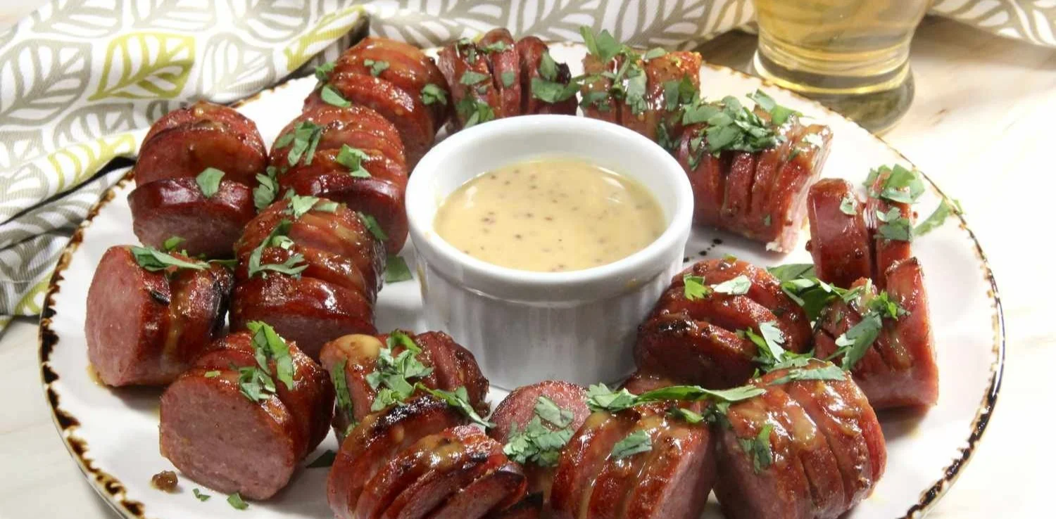 Crispy air fryer kielbasa bites served in a bowl with dipping sauce.