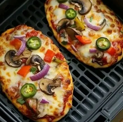 Homemade air fryer naan pizza topped with fresh ingredients