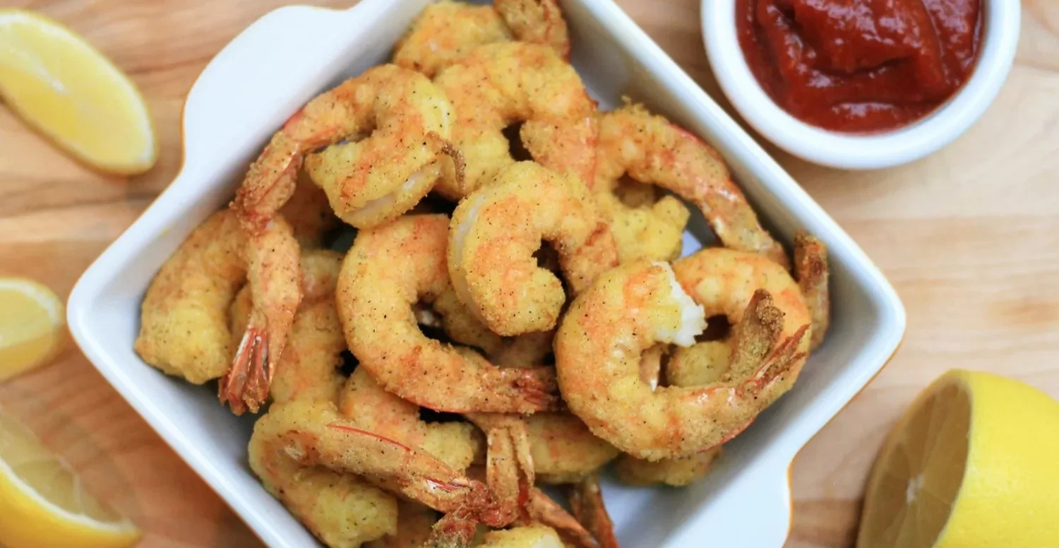 Crispy air fryer shrimp served with dipping sauce for a delicious meal.
