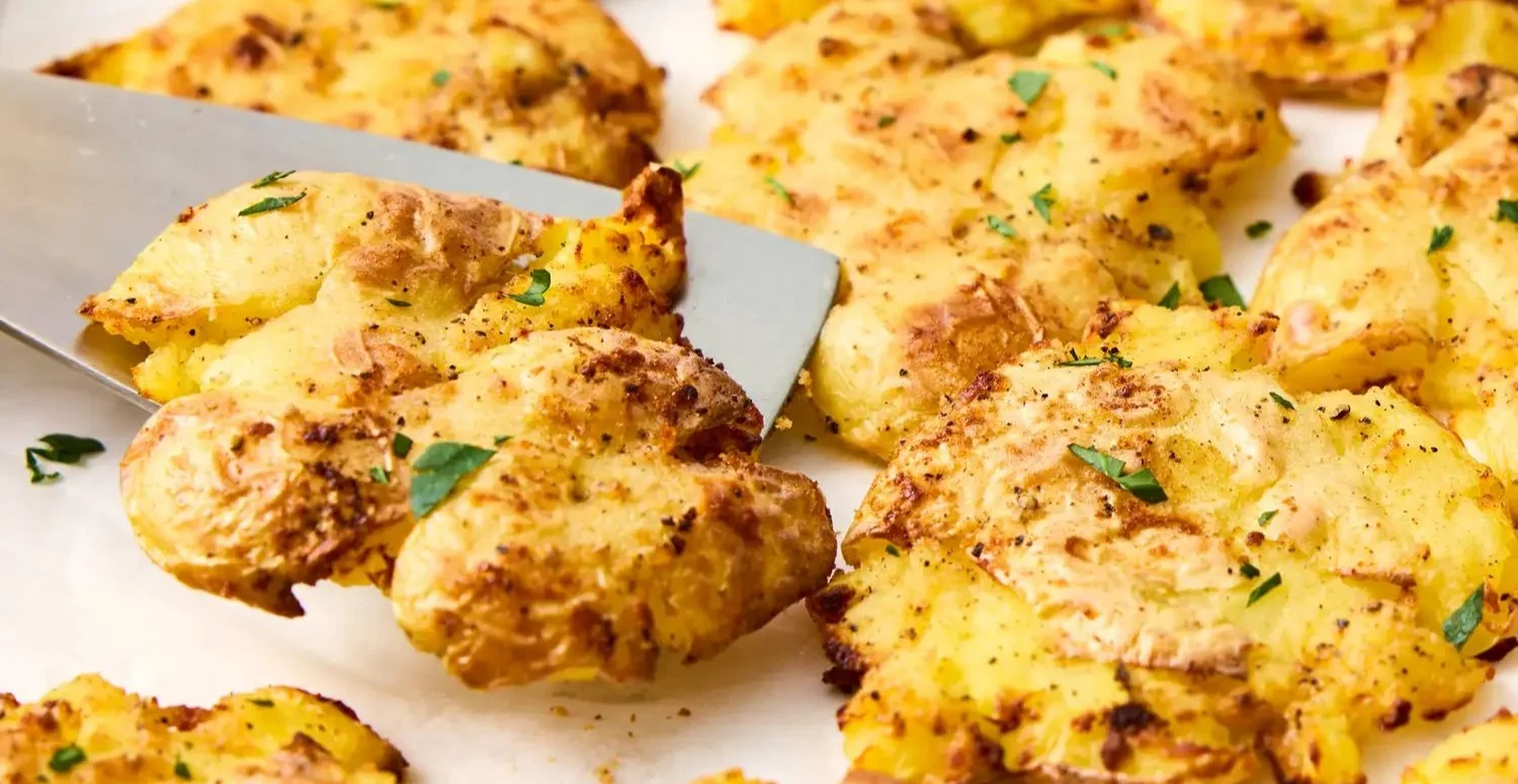 Delicious air fryer smashed potatoes served on a plate.