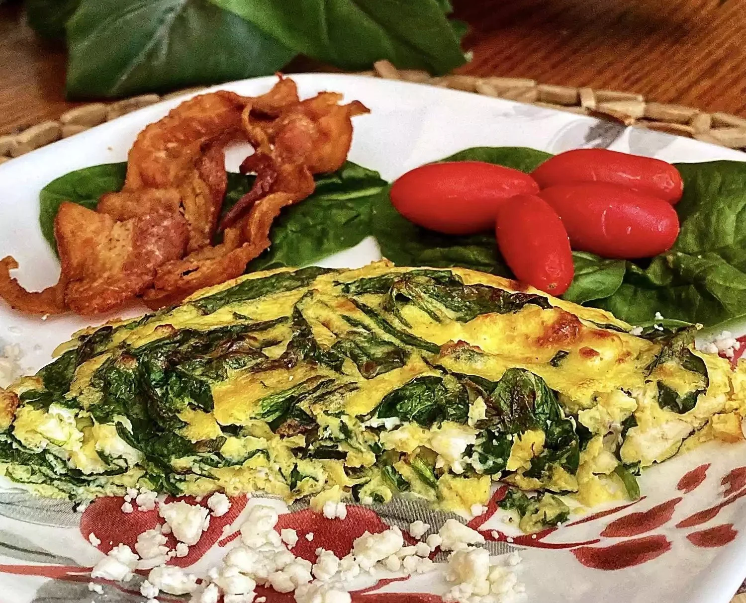 Delicious Air Fryer Spinach-Feta Frittata on a plate with fresh herbs