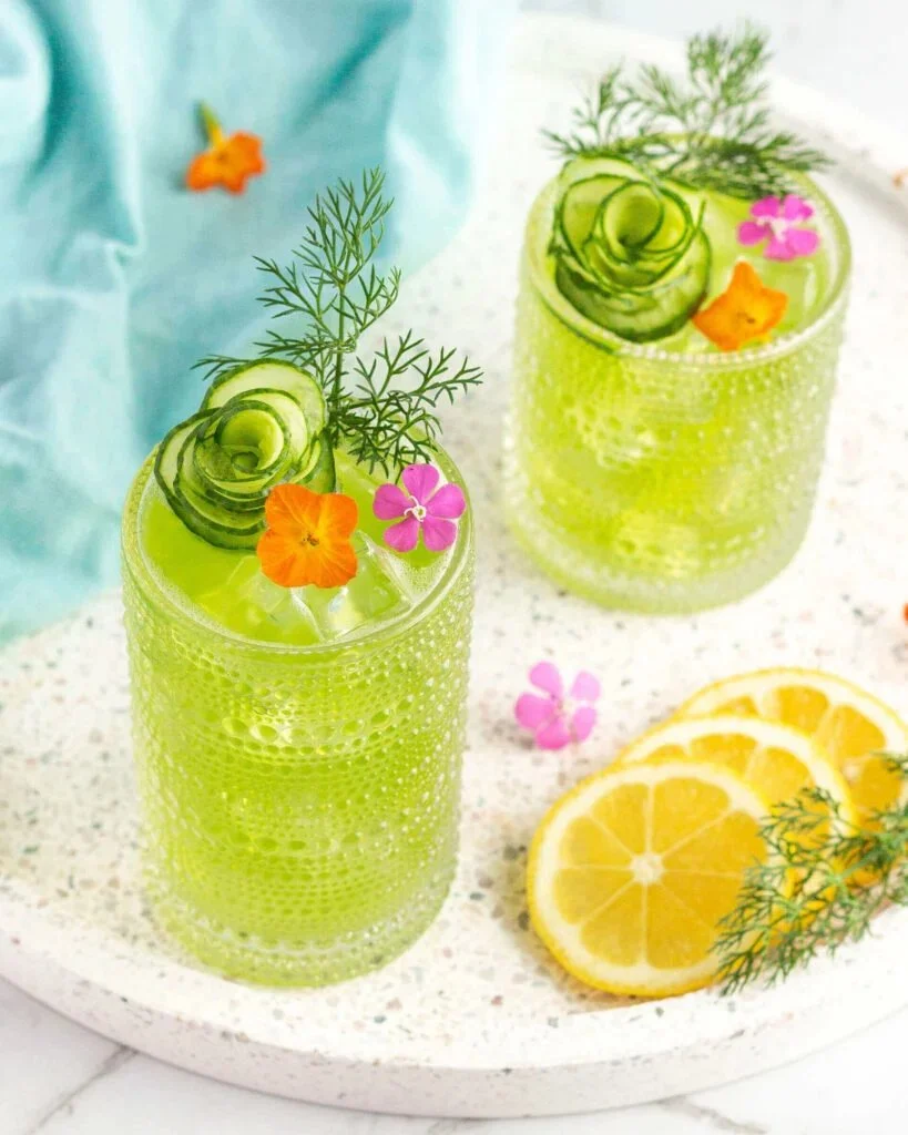 Beautiful drink garnishes including apple roses and cucumber flowers for cocktails.
