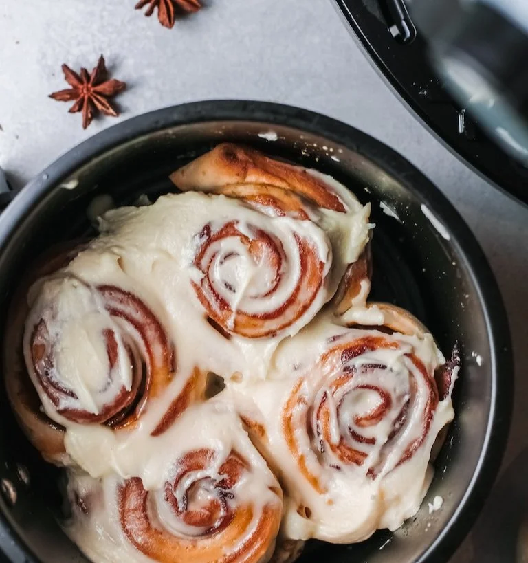 Delicious Bacon Cinnamon Rolls topped with crispy bacon and creamy icing