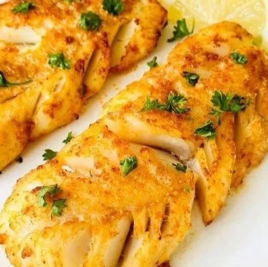 Crispy and flaky air fryer cod served with lemon and herbs