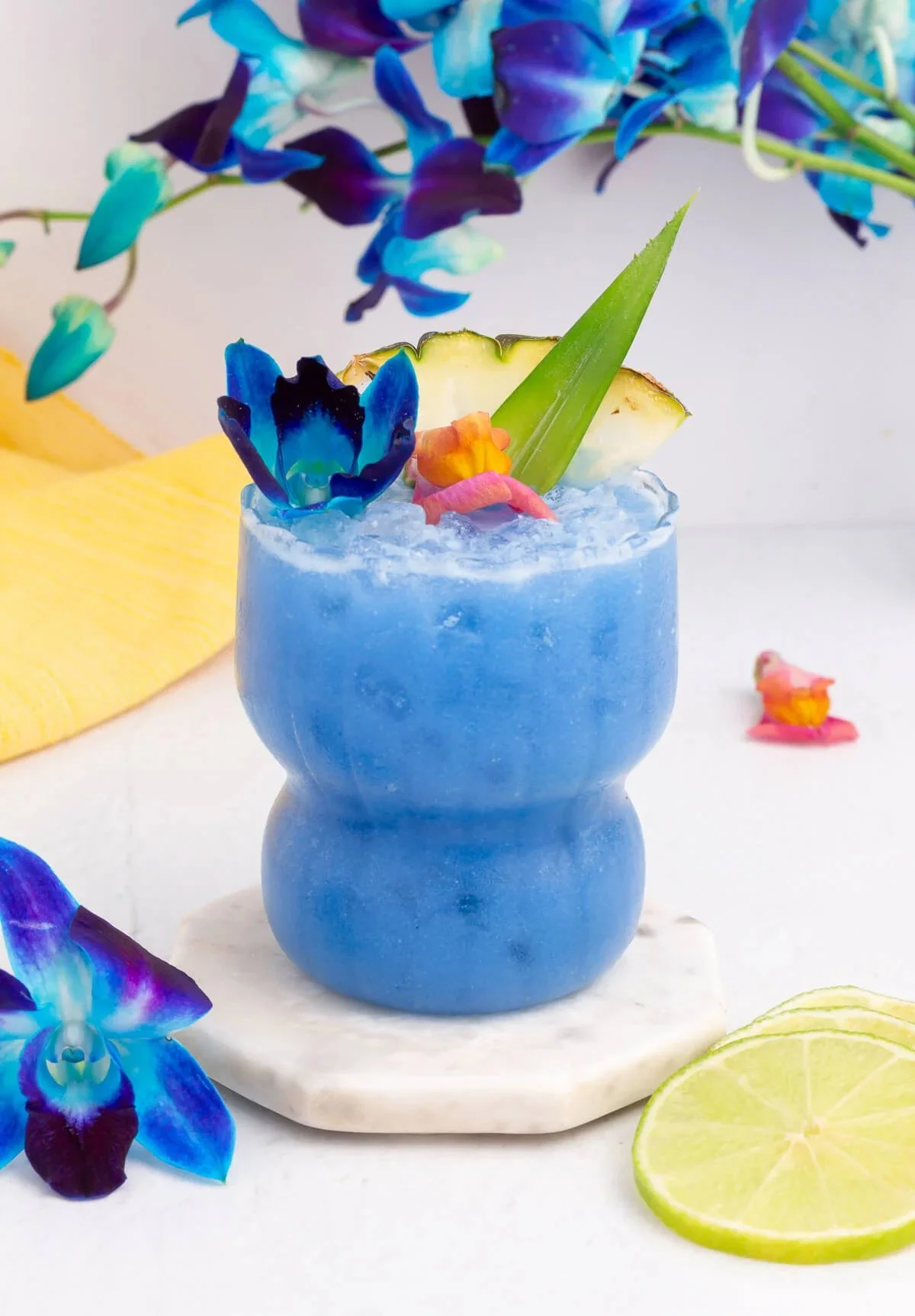 Blue Hawaii Mocktail in a glass garnished with tropical fruits