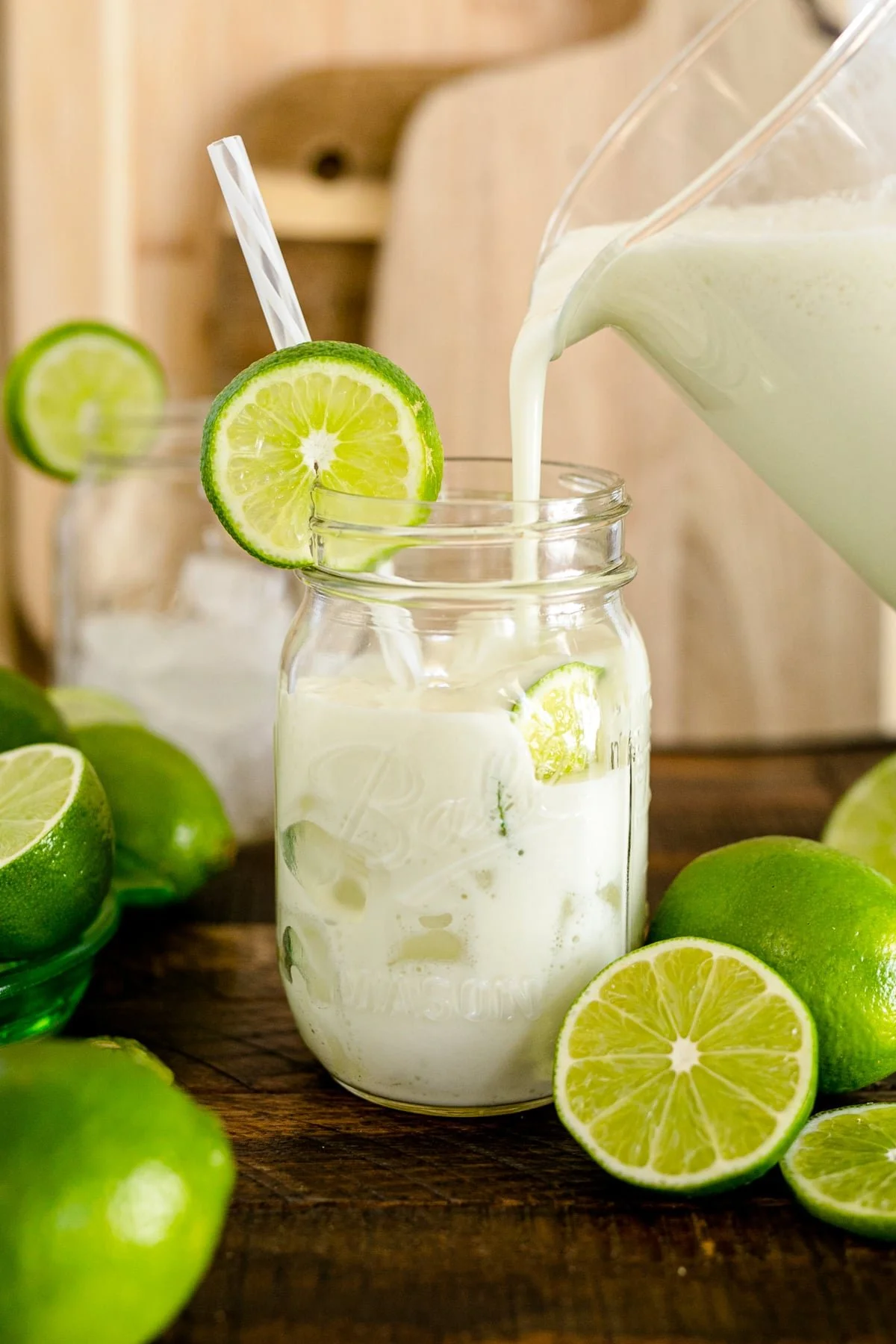A refreshing glass of Brazilian Lemonade garnished with lime slices