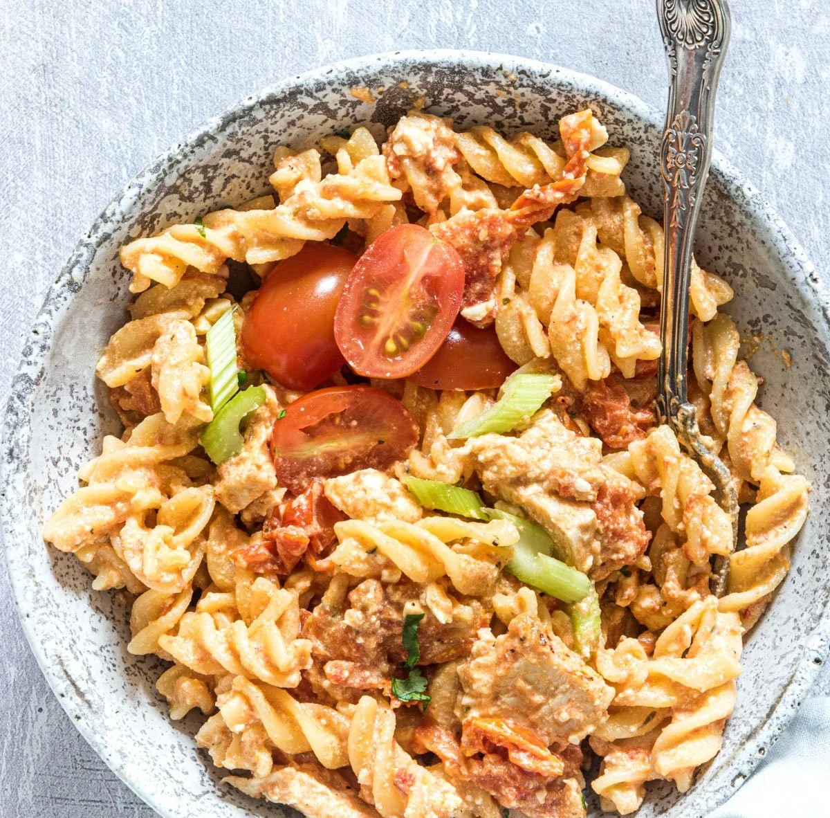 Buffalo Chicken Baked Feta Pasta served in a bowl with fresh herbs