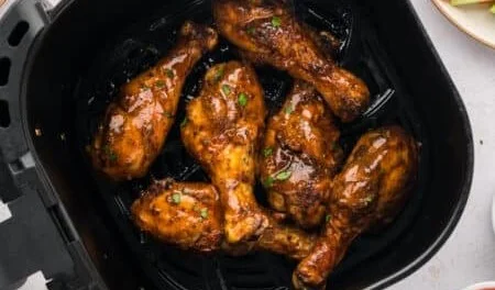Plate of flavorful Buffalo Chicken Drumsticks garnished with celery and blue cheese