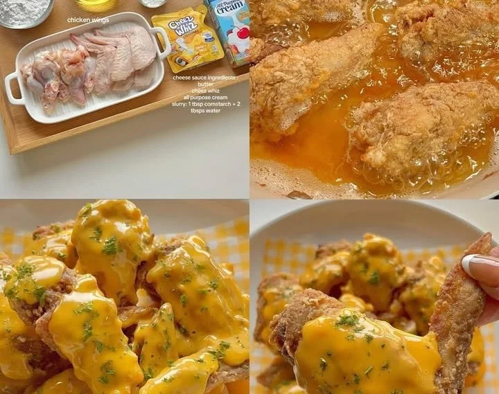 Cheesy chicken wings garnished with herbs on a white plate
