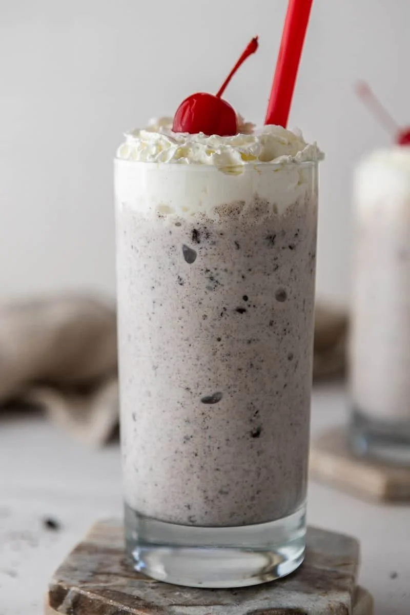 Chick-fil-A cookies and cream smoothie in a glass with whipped cream