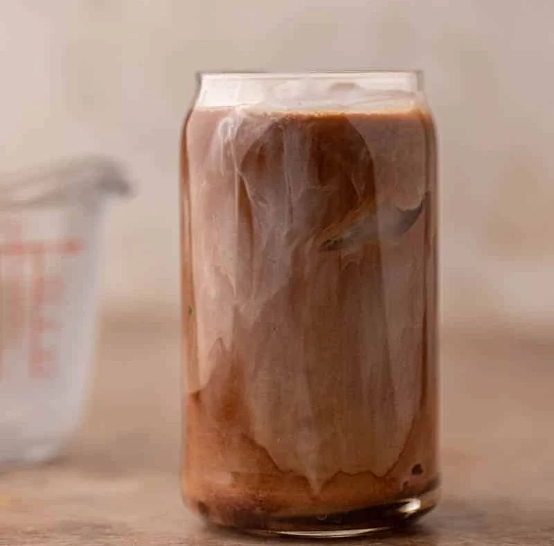 Chick-Fil-A mocha cream cold brew served in a glass with ice and whipped cream.