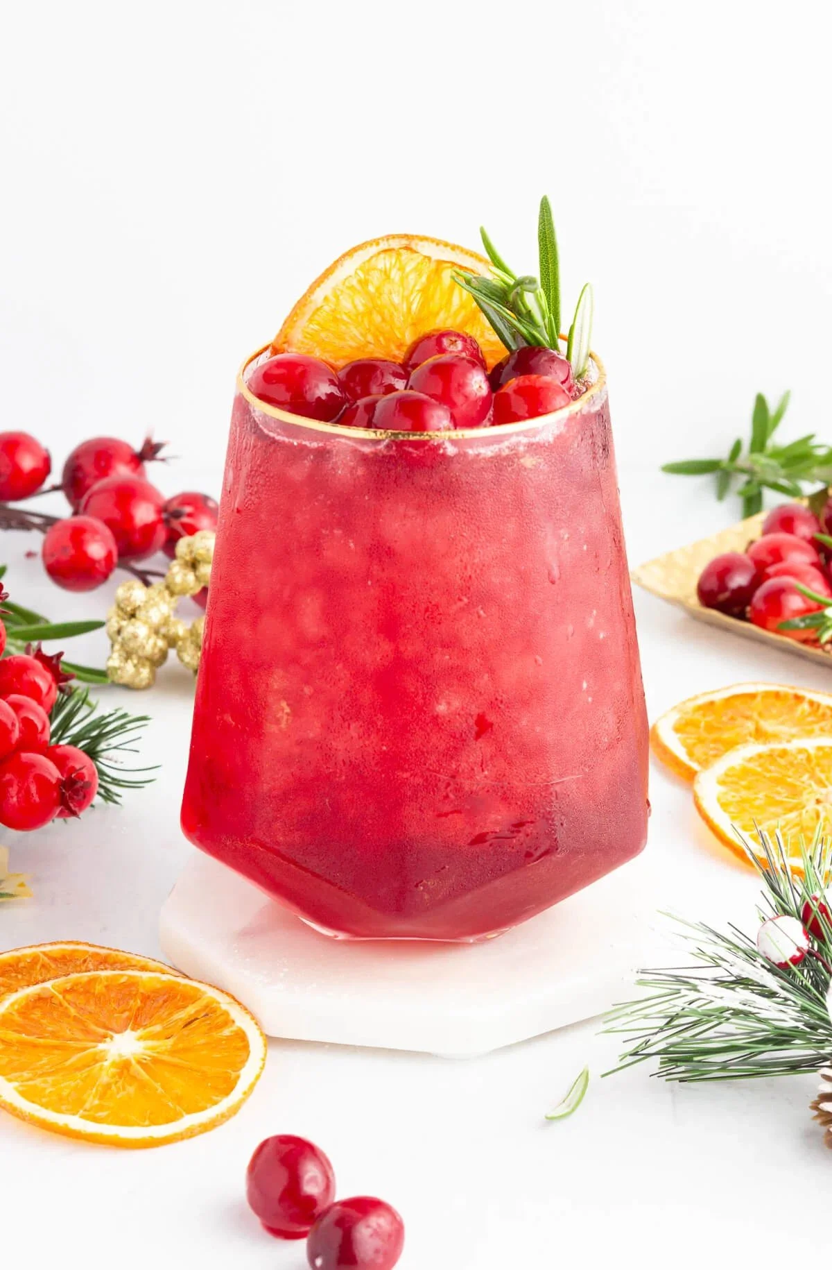 Cranberry Mocktail with 3 ingredients in a glass garnished with berries and mint