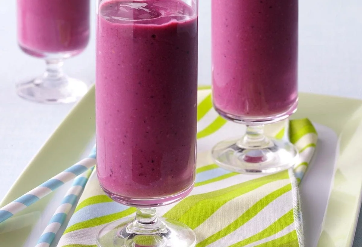 Creamy berry smoothies with mixed berries and yogurt in a glass.