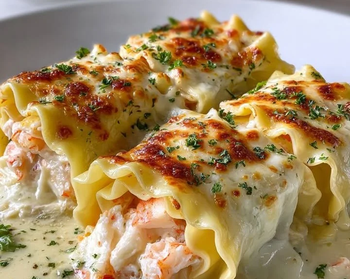 Creamy seafood lasagna roll-ups with shrimp and scallops on a plate