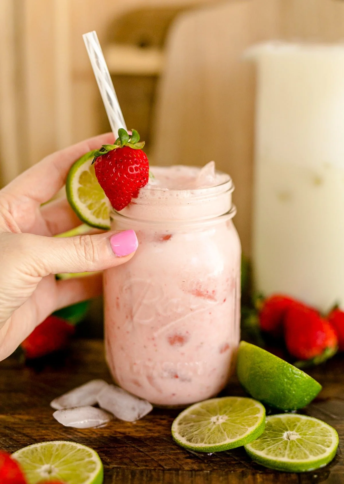 Delicious creamy strawberry limeade in a glass with fresh strawberries and lime slices