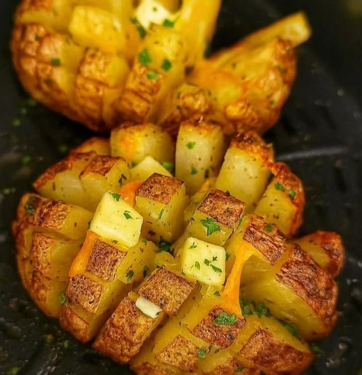 Crispy Blooming Baked Potato served on a plate with toppings
