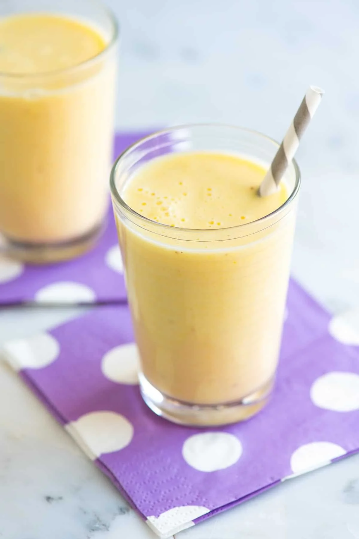 Delicious banana smoothie in a glass decorated with banana slices